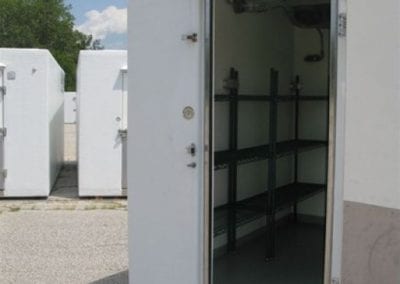 Inside of a portable walk in cooler for rent with shelving