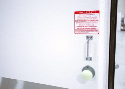 Door handle and red sign of cooler freezer rental